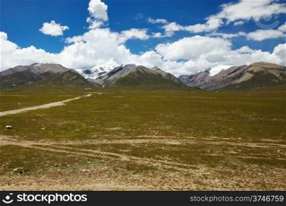 Green plains with mountain landscape at the Tibetan Plateau