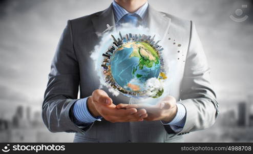 Green planet. Businessman hands holding Earth planet. Elements of this image are furnished by NASA