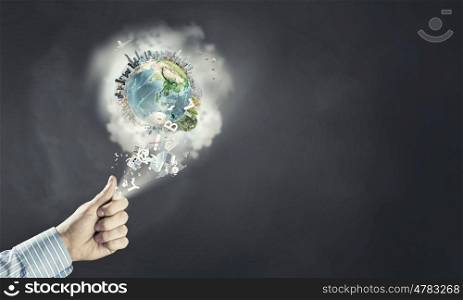 Green planet. Close up of human hand catching Earth planet. Elements of this image are furnished by NASA