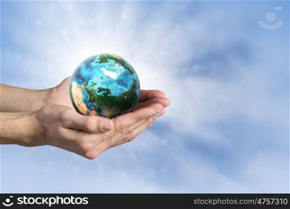 Green planet. Close up of human hands holding Earth planet. Elements of this image are furnished by NASA