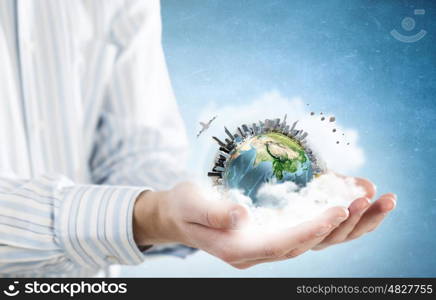 Green planet. Close up of human hands holding Earth planet. Elements of this image are furnished by NASA