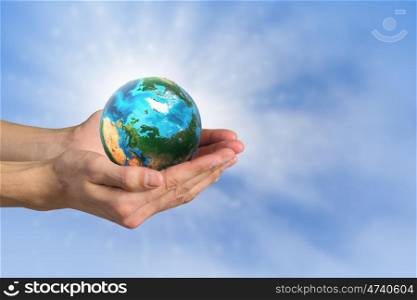 Green planet concept. Close up of human hands holding Earth planet. Elements of this image are furnished by NASA