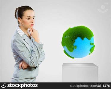 Green planet. Image of thoughtful businesswoman looking at earth planet