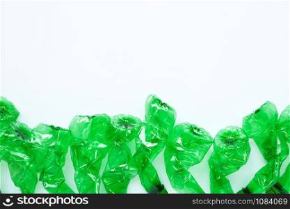Green plastic bottles on white background. Copy space