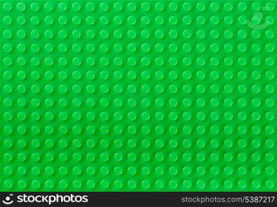Green plastic toy constructor background