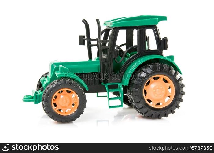green plastic tractor over a white background