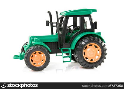 green plastic tractor over a white background