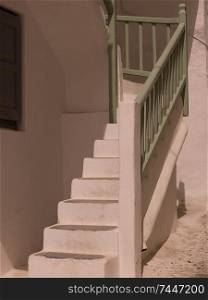 Green railing on staircase in Mydonos Greece