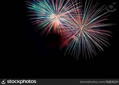 Green Red Sparkling Fireworks Background on Night Scene. Abstract color fireworks background and smoke on sky