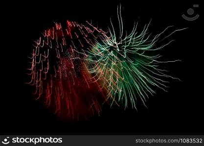 Green Red Sparkling Fireworks Background on Night Scene. Abstract color fireworks background and smoke on sky