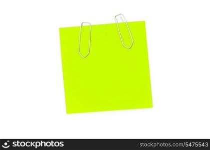 Green reminder note with paperclips isolated on the white