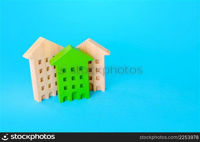 Green residential building among houses. Environmentally friendly, energy efficient. New sustainable building codes and standards. Search for best option to buy. Net Zero Carbon neutrality.