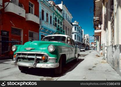 Green retro car parked on the street of Havana, Cuba