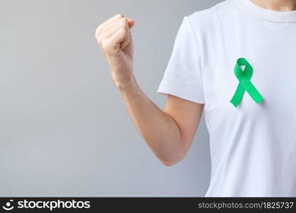 green Ribbon for Liver, Gallbladders, bile duct, cervical, kidney Cancer and Lymphoma Awareness month. Healthcare and world cancer day concept