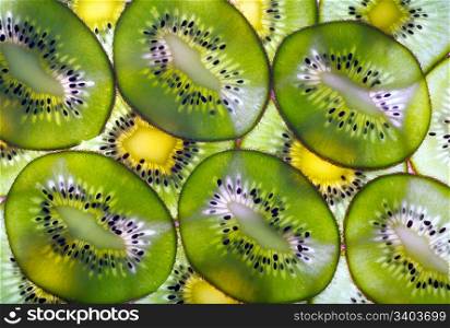 Green ripe kiwi macro sliced cuts background