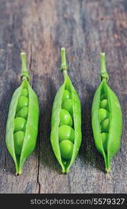 Green ripe pea vegetable isolated on old wooden background