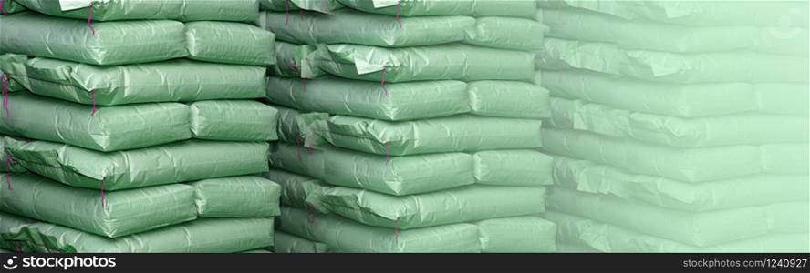 Green sacks store in industrial warehouse. Background with copy space