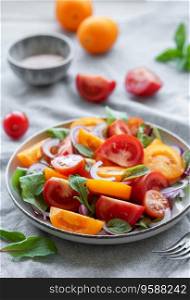 Green salad from leaves and tomatoes.  Healthy food. 