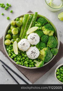 Green salad with rice and vegetables. Salad with lemon, cucumber, peas and broccoli. Top view