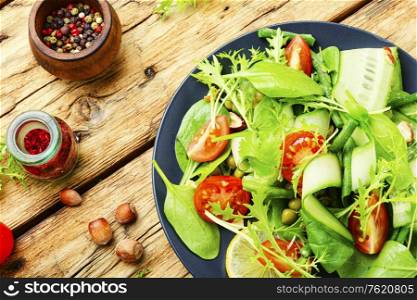 Green salad with vegetables and nuts.Healthy food. Vegan healthy seasonal salad