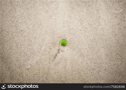 Green sanded glass in the water on a beach washed up on the shore in the summer