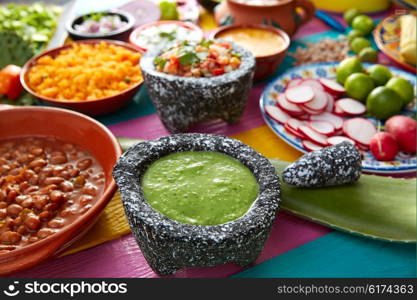 Green sauce with tomato and chili pepper in a mexican food table