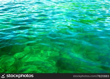 green sea with small waves at sunny day