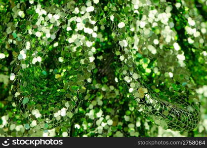 Green sequins abstract close up background.