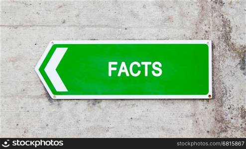 Green sign on a concrete wall - Facts