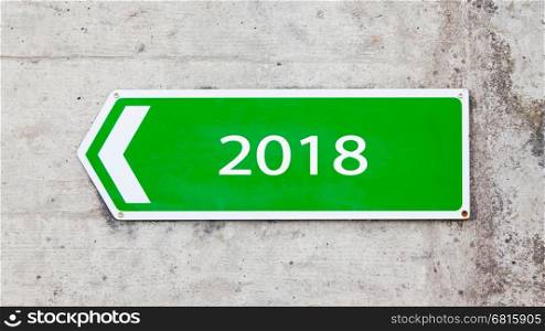 Green sign on a concrete wall - New year - 2018