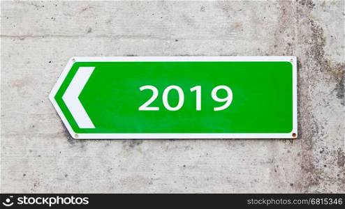 Green sign on a concrete wall - New year - 2019