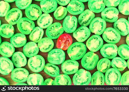 Green sliced tomato with red tomato in centre, food concept background, green tomato texture