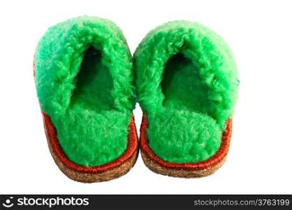 green slippers on a white background of wool sheep