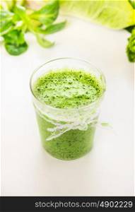 Green smoothie in glass, close up