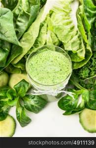 Green smoothie in glass with ribbon and vegetables frame