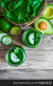 Green smoothie on rustic wooden background