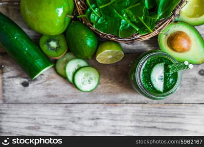 Green smoothie on rustic wooden background