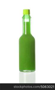 Green spicy sauce in a little bottle isolated on a white background