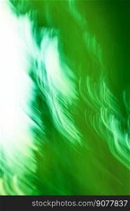 Green spiral of sparks swirling around.Spiral light effects in bright green colors.. Defocused green motion blur swirling background. Colourful vortex blur green background.