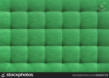 Green suede leather background for the wall in the room. Interior design, headboards made of furniture fabric, furniture upholstery. Classic checkered pattern for furniture, wall, headboard. Green suede leather background, classic checkered pattern for furniture, wall, headboard