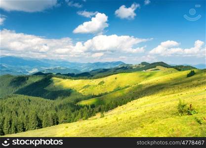 Green sunny valley in mountains and hills. Nature landscape