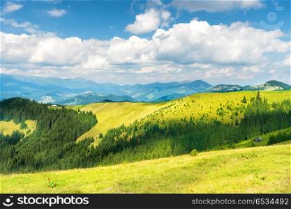 Green sunny valley in mountains and hills. Nature landscape. Green sunny valley in mountains