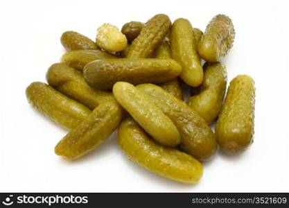 Green tasty pickles lie on a white background a small group