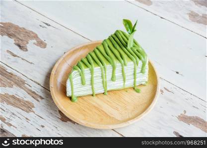 green tea crepes cake on the wood plate.