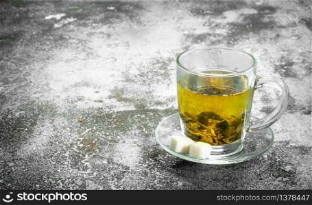 Green tea in a glass cup. On a rustic background.. Green tea in a glass cup.