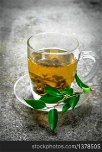 Green tea in a glass cup. On a rustic background.. Green tea in a glass cup.