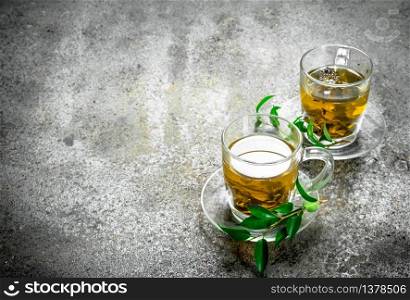 Green tea in a glass cups. On a rustic background.. Green tea in a glass cups.