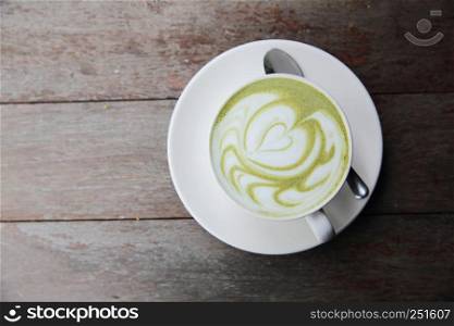 green tea latte on wood background