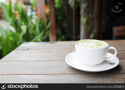 green tea latte on wood background