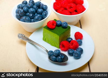 green tea matcha mousse cake with raspberries and blueberries on top